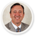 Smiling professional in suit, embodying SysAid's ITSM expertise, poised to enhance your Service Desk efficiency. - SysAid