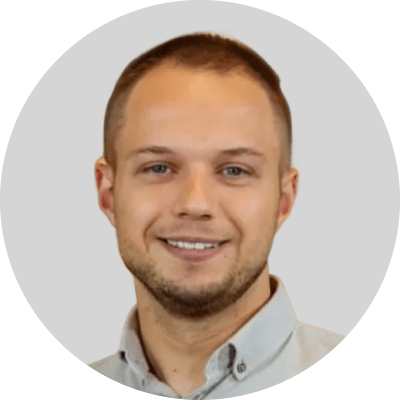 Professional man in collared shirt, representing SysAid's Service Desk support team on a light gray background. - SysAid