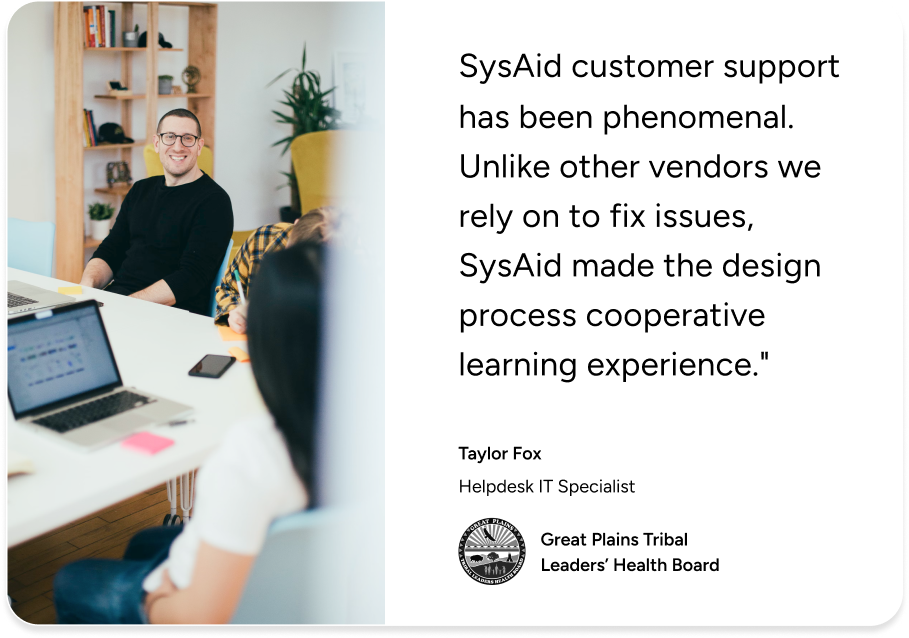 Two people at laptops review a SysAid customer support testimonial, highlighting Help Desk expertise from Taylor Fox. - SysAid