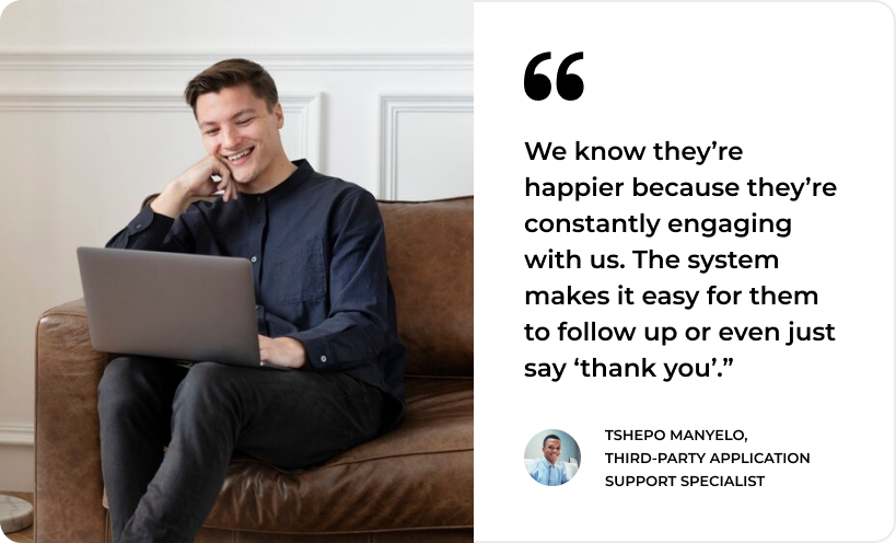 Man smiling at laptop; quote on customer engagement by Tshepo Manyelo, reflecting SysAid's ITSM Service Desk excellence. - SysAid
